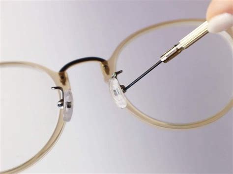 fixing nose piece on glasses.